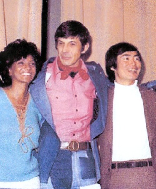 With Nichelle and George at a 1974 Convention. The ascot king strikes again -- this time in a fashion forward (for the time) incredible denim patchwork suit! I remember he wore this on his Mike Douglas show appearance, sorry I don't have full length shot of it! Love Nichelle's sweater here too.