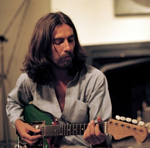 George Harrison with green guitar Living in the Material World